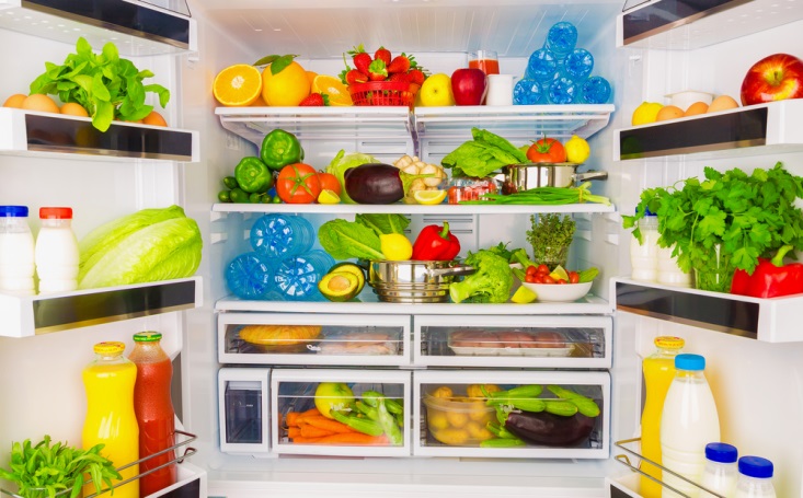 refrigerator stocked with colorful fruit and veggies